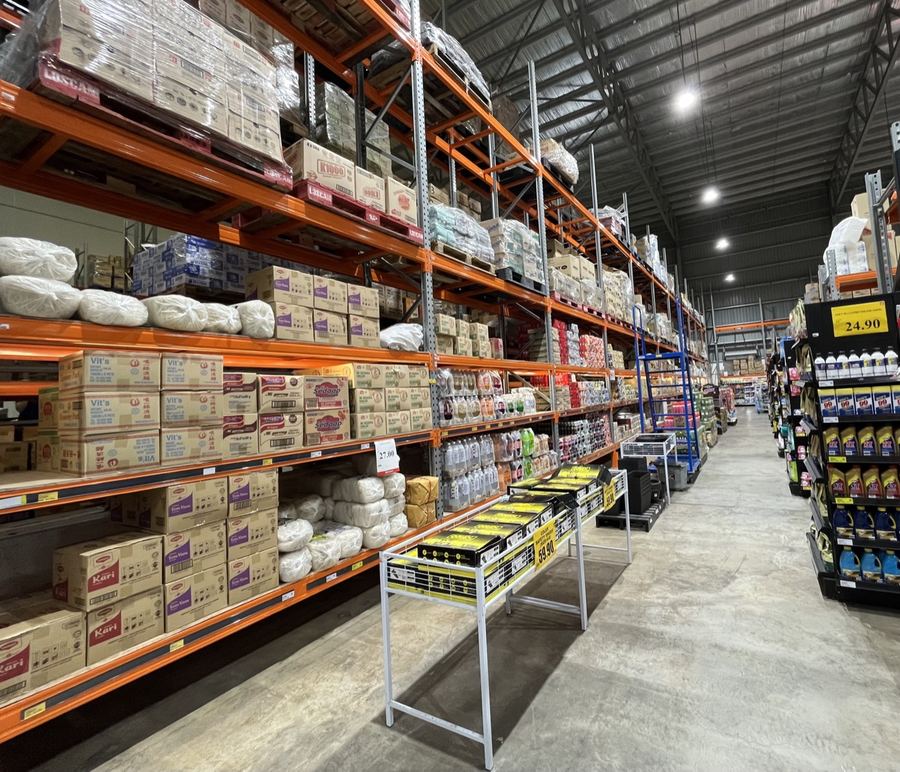 Stocked grocery aisles inside the SC Wholesale warehouse